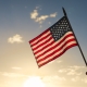 Person holding american flag.