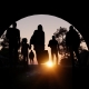 Refugees and immigrants looking for a new hope in life. Silhouette. Column of migrants passing through a tunnel. Abandon your lands for a better future. 3d rendering