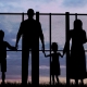 Silhouette of a refugees family with children