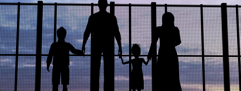 Silhouette of a refugees family with children