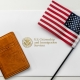 U.S. Department of State envelope for US American passport on table with flag and passport case cover flat top illustrative editorial view