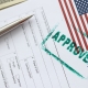 USA visa approved rubber stamp and application form. Assistance in obtaining and processing visas to USA concept