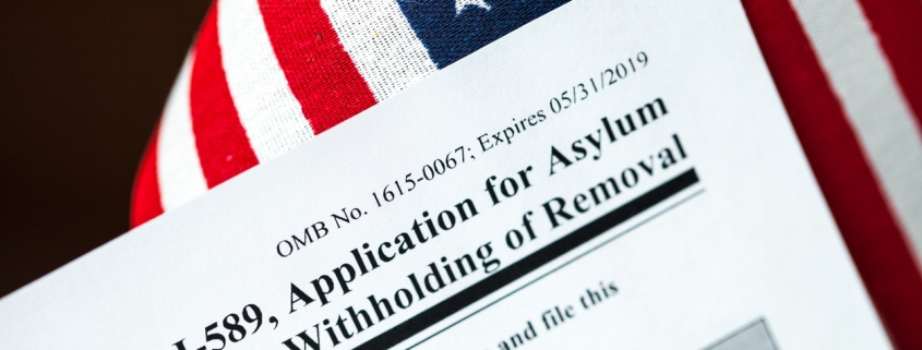 Application for asylum to USA concept with application form and USA flag