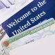 Welcome to the USA. Immigration Welcome Letter and Green Card Closeup. United States Homeland Security.