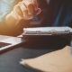 Man stamping approval of work finance banking or investment marketing documents on desk.