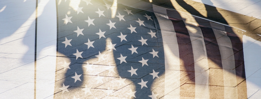 Shadows of People in a street and Flag of The USA as Background concept toned Picture