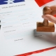 Immigration to USA. Woman stamping visa application form on flag, closeup